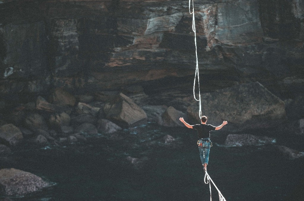 man balancing tightrope, psychedelic risks and concerns